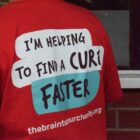 A red T shirt with the words I'm helping to find a cure faster